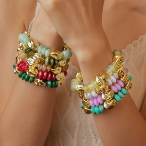 Multi-layered bohemian acrylic beaded bracelet with colorful gems on model's wrist