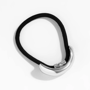 Detail of silver metallic arc piece on black high-elastic minimalist hair tie band