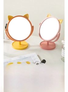 Detail of pink and orange cat-ear desk mirrors with 360-degree rotation feature