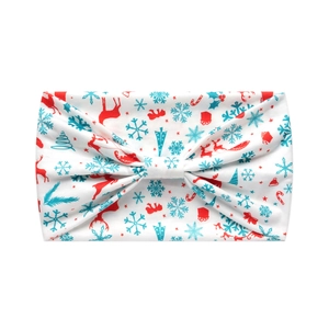 Detail of Christmas knot headband featuring reindeer and snowflake prints on soft fabric
