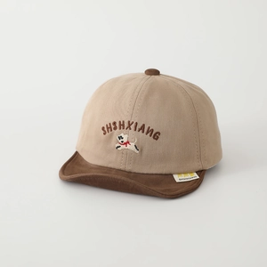 Detail of baby baseball cap with cartoon dog embroidery and soft brown brim for autumn