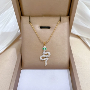 Snake pendant necklace with green eyes and white crystals on gold titanium steel chain