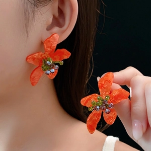 Vintage orange flower earrings with marble texture petals and colorful crystal center