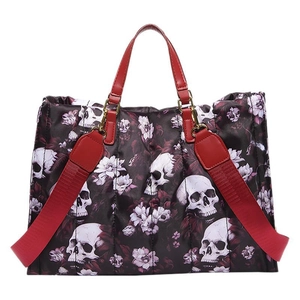 Dark gothic tote bag with white skull and purple floral print featuring red leather handles