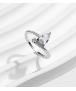 Macro shot of S925 silver ring featuring pear-cut diamond and pave-set detailing