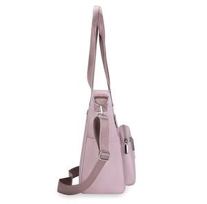Side view of a pink nylon crossbody bag showing durable shoulder strap and zipper pocket