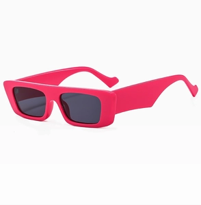 Detail of trendy pink rectangular sunglasses with wide temples and dark UV lenses
