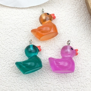DIY colorful luminous resin duck charms in orange, green and purple with metal loops