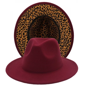 Detail view of burgundy wide brim fedora hat featuring a stylish leopard print lining