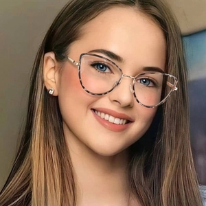 Close-up of golden metal cat-eye glasses with tortoiseshell detail on female model