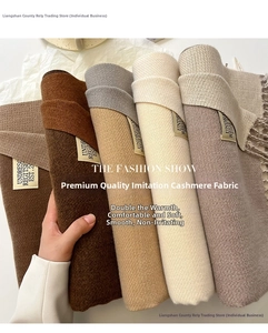 Detailed texture of soft cashmere-like scarves with fringe and minimalist brand tags