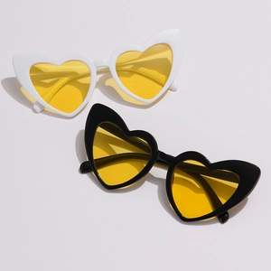 Fashionable heart-shaped oversized sunglasses in black and white frames with yellow lenses