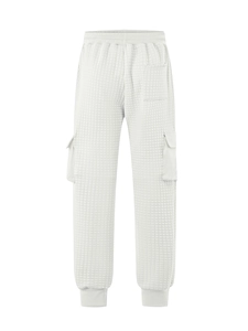 Macro view of white quilted fabric texture and side cargo pocket on men joggers