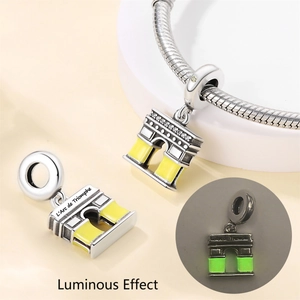 Luminous Arc de Triomphe charm showing glowing green effect on silver chain