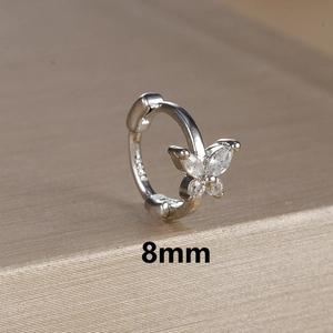 Detailed macro view of 8mm silver butterfly ear cuff with sparkling zircon inlay