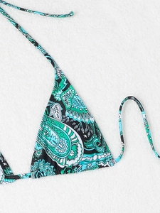 Detailed macro view of the vibrant paisley print on this tie-up triangle bikini top