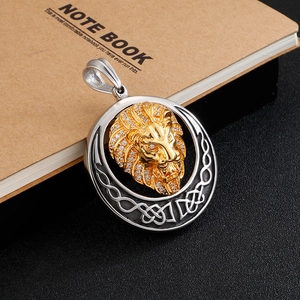 Detailed close-up of a gold-plated lion head pendant with sparkling cubic zirconia stones