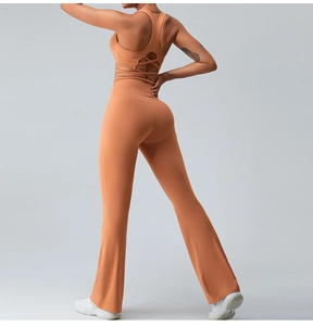 Detail of cross-back yoga top and flare yoga pants in burnt orange stretch fabric