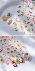 Close-up of 5D embossed Christmas nail stickers featuring laser glitter Santa and dog motifs