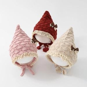 Knitted baby pixie hats with lace trim and bow ties in pink, red, and beige colors