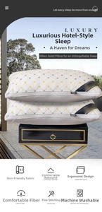 Macro view of white quilted hotel pillows with diamond patterns and dark blue piping