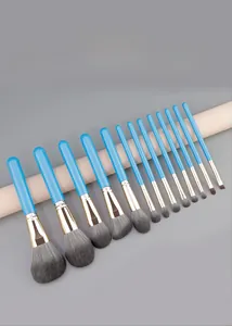 Detail of 12-piece makeup brush set with blue handles and soft grey synthetic bristles