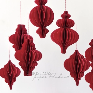 Hanging dark red paper honeycomb ornaments for Christmas tree and festive party decor