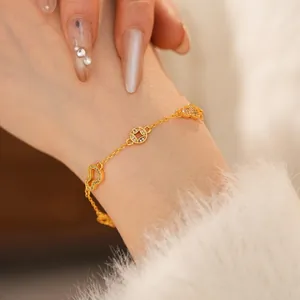 24k gold plated bracelet featuring hollow butterfly and coin charms with zircon inlay