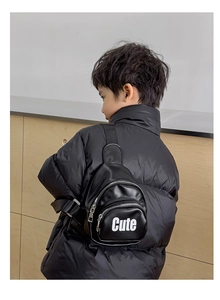 Detail view of children's black PU leather chest bag with Cute letter embroidery
