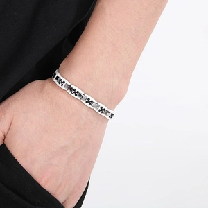 Gros plan d'un bracelet magnétique en céramique et acier tungstène noir et blanc