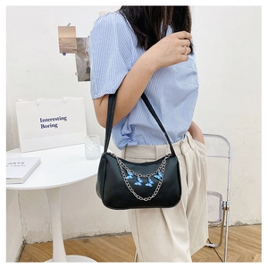 Shoulder bag in black PU leather with silver chain and blue butterfly charm detail