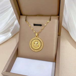 Elegant gold titanium sunflower face necklace with pavé crystals on silk background