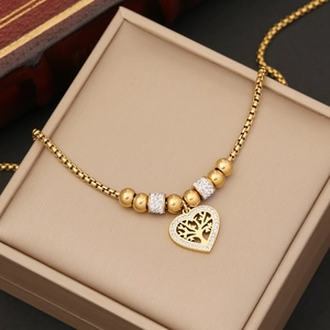 Detail of gold heart Tree of Life necklace with rhinestones in a jewelry box