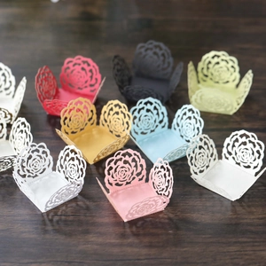 Detailed laser-cut rose patterns on cupcake wrappers in various elegant colors