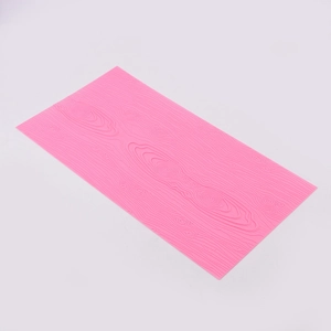 Detail of pink silicone mat showing intricate tree bark texture for DIY cake decorating