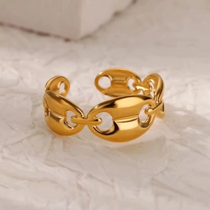 Macro shot of 18k gold plated stainless steel hollow chain ring with smooth metal texture