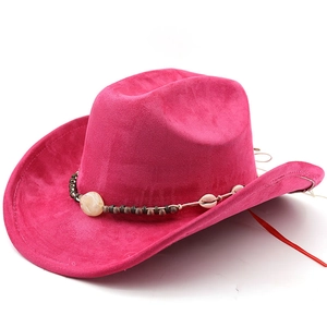Detail of fuchsia suede cowboy hat featuring woven band with shells and beads