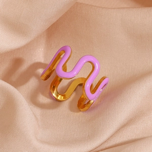 Detail of 18K gold plated wavy ring with purple enamel texture on champagne silk