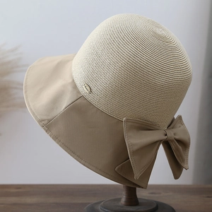 Detail of the chic straw weave texture and fabric bow accent on this sun hat