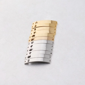 Detailed macro of curved stainless steel connectors with star and crown cutout patterns