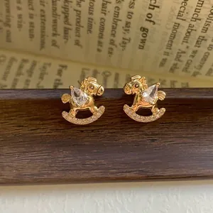Elegant gold plated rocking horse earrings with sparkling teardrop zircon stones