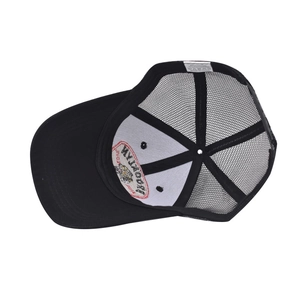 Detail of the Brooklyn embroidered patch and interior mesh structure of the black trucker hat