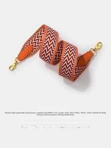 Detail of orange woven wax thread wide shoulder strap with cowhide ends and gold clasps