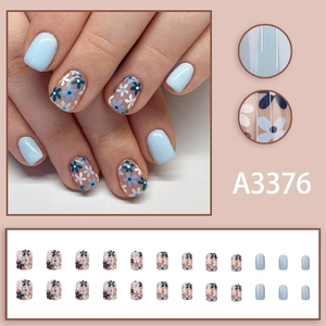Short square blue floral press-on nails with daisy designs and clear accents, 24 piece set