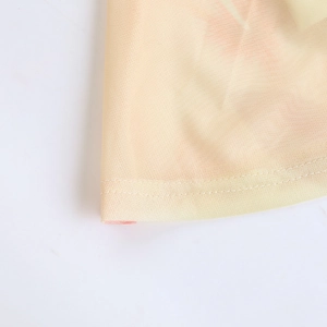 Detail of breathable yellow mesh fabric with floral print and double-needle hem stitching