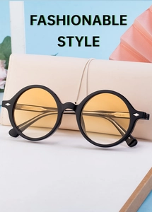 Detailed macro view of vintage round sunglasses with yellow lenses and silver rivets