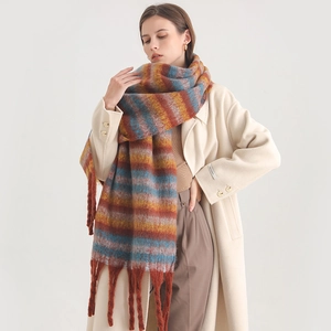 Close-up of thick striped cashmere-like scarf with long tassels and vibrant multi-color weave