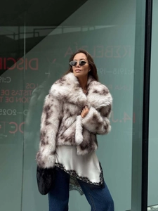 Close-up of faux fur short jacket with spotted pattern and lace-trimmed camisole top
