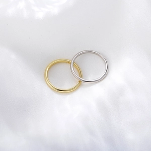 Minimalist gold and silver S925 sterling silver rings on white silk fabric background