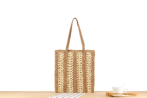 Detailed macro view of woven paper rope tote with vertical brown and beige stripes